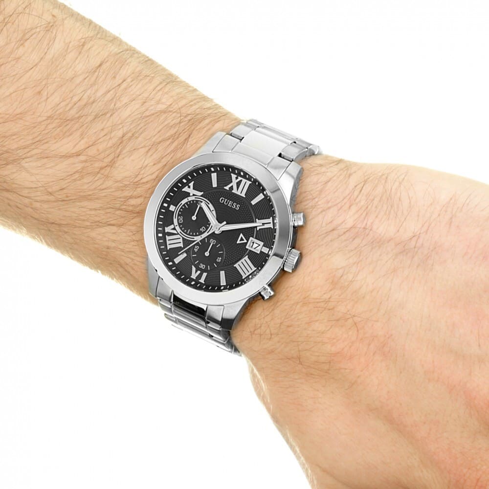 Guess W0668G3 chronograph watch worn on wrist showing black dial and metal bracelet